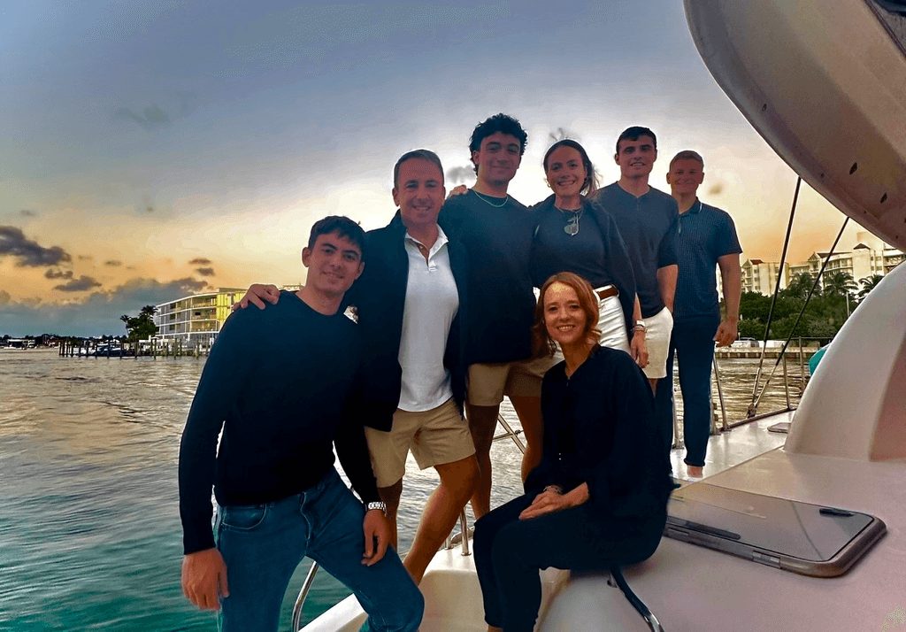The Persistent team on a boat at sunset